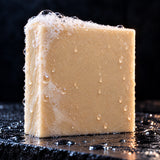 Close up of the Frankinsexy soap bar with fresh lather on wet slate