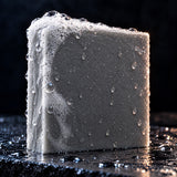Close up of the Peppermint Trail soap bar with fresh lather on wet slate