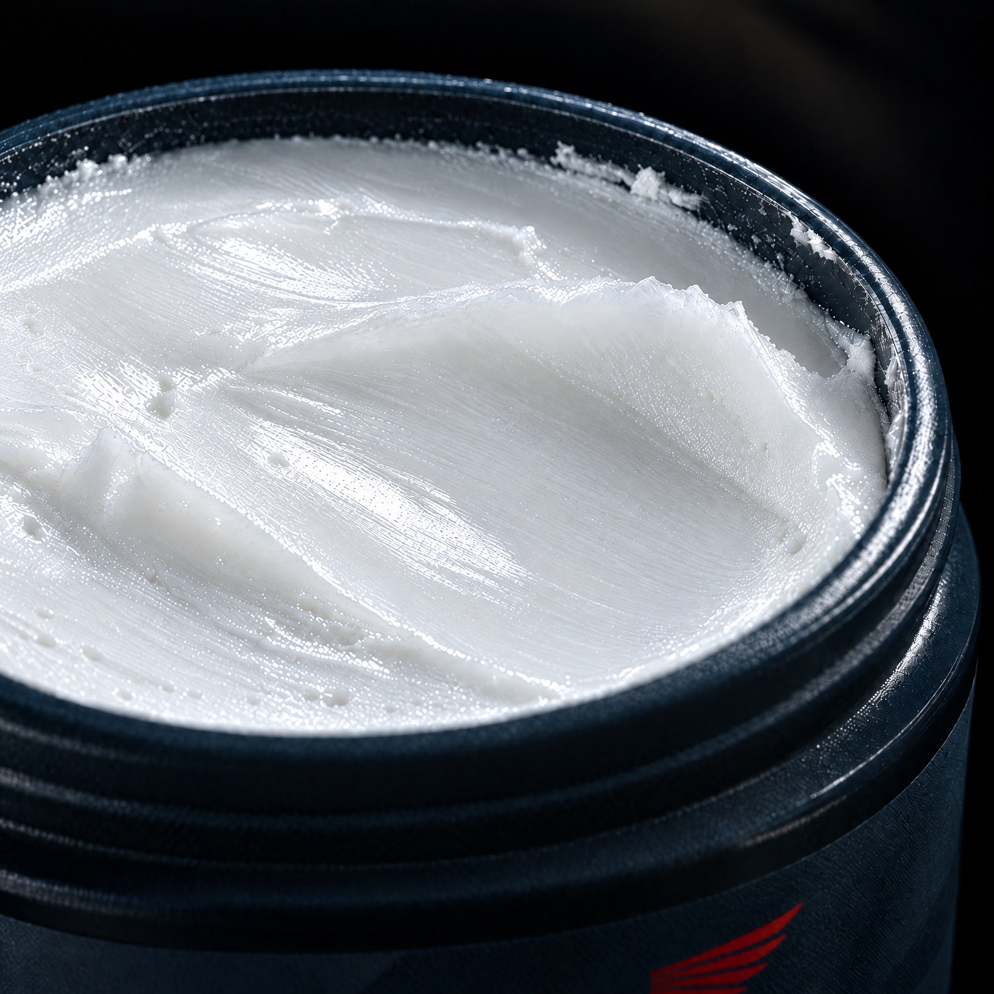 Close up of the whipped grass-fed tallow balm inside an open Balm of the Brave jar