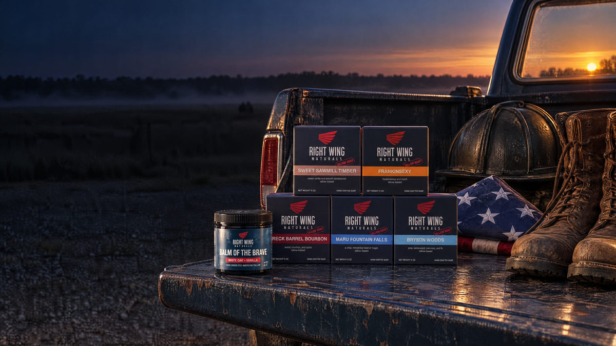 Right Wing Naturals bars and Balm of the Brave on a truck tailgate at sunset beside a folded flag and work boots